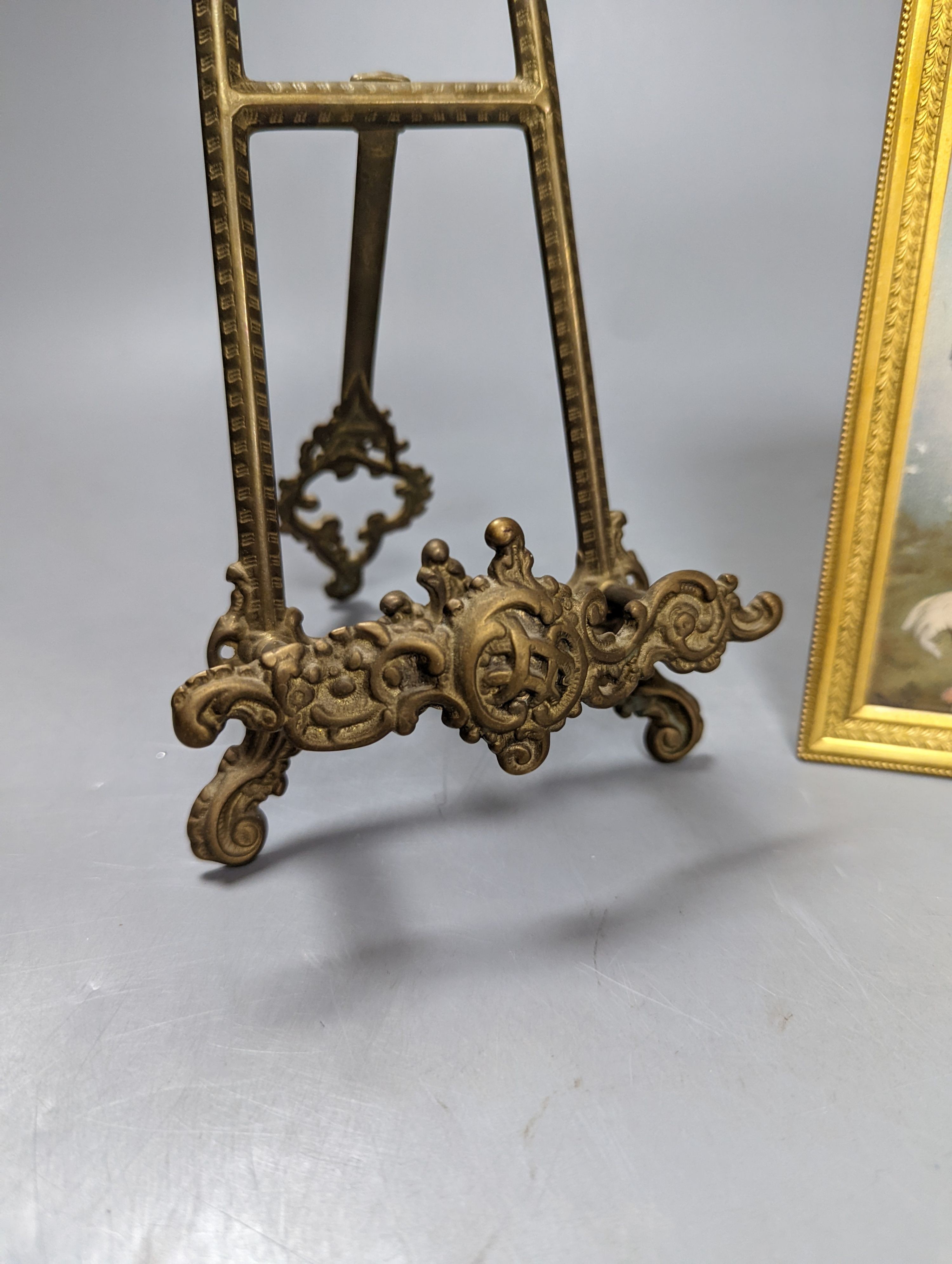 Victorian miniature print of a lady in a black feather hat in a gilt brass frame and a small brass easel, easel 25 cms high.